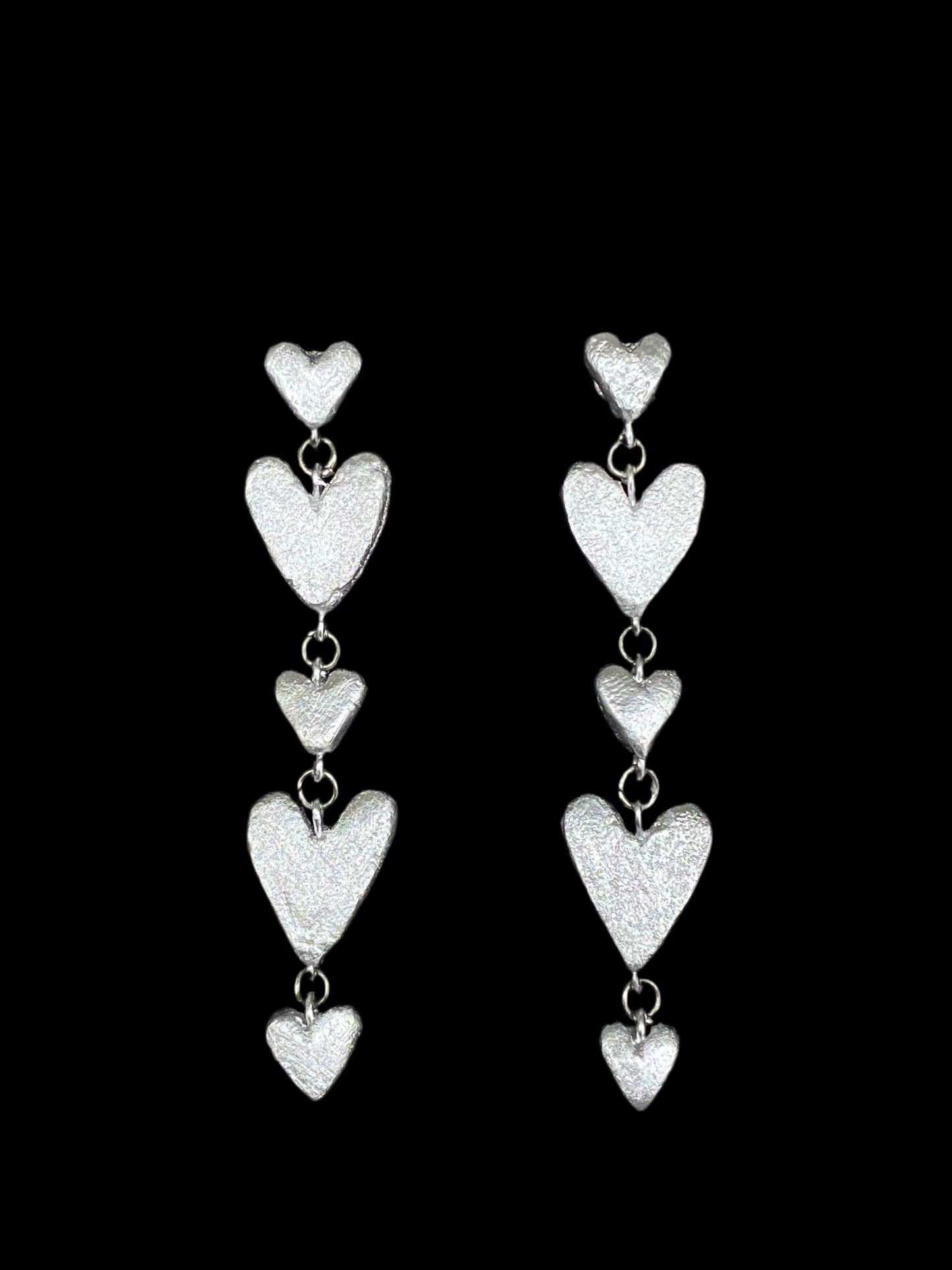 Six dangling heart earrings